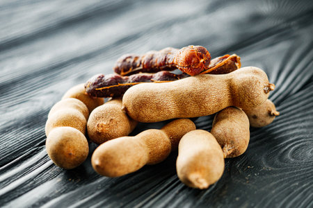 sweet and sour tamarind on a black rustic wooden background.の写真素材