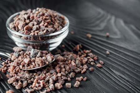 crystalline black Himalayan salt on a black wooden background.の写真素材