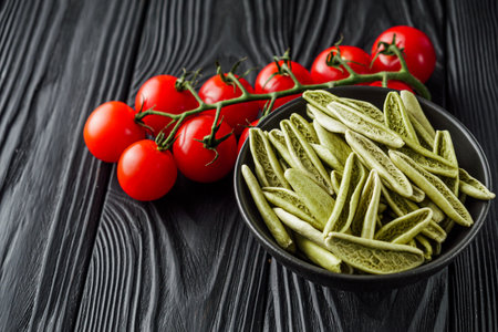 raw green cavatelli pasta on a black wooden background.の写真素材