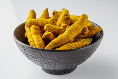 aromatic turmeric root on a white acrylic background.の写真素材