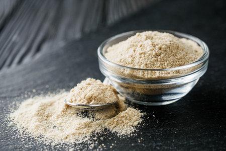 asafoetida aromatic powder on a black stone background.の写真素材
