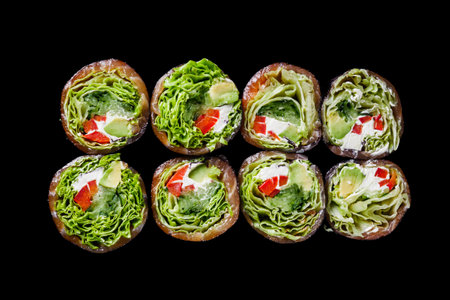 vegetarian futomaki sushi roll with cucumber, salmon, pepper, avocado salad on a black mirror background.の写真素材