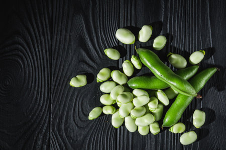 fresh greens broad beans fava on a dark background.の写真素材