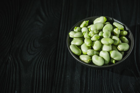 fresh greens broad beans fava on a dark background.の写真素材