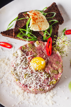delicious fresh beef tartare on a white plate.の写真素材