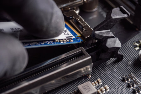 a specialist installs a solid-state drive in the m2 connector.の写真素材