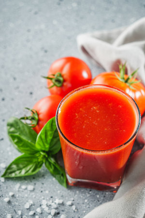fresh tasty natural tomato juice on a light stone background.の写真素材