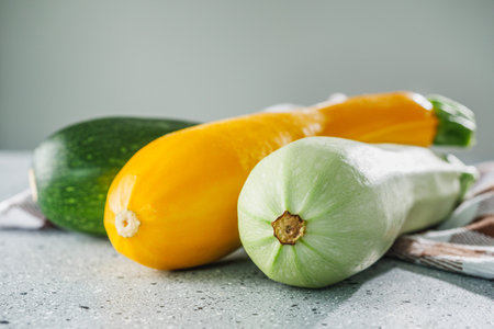 fresh natural zucchini on a light stone background.の写真素材