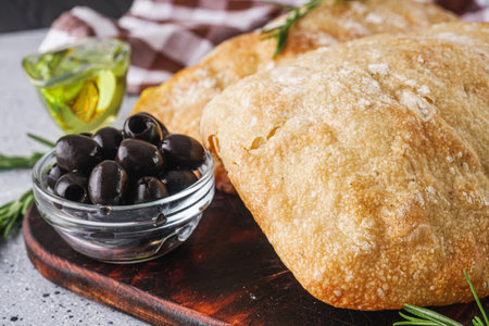 Fragrant freshly baked traditional Italian ciabatta on a stone rustic background.の写真素材