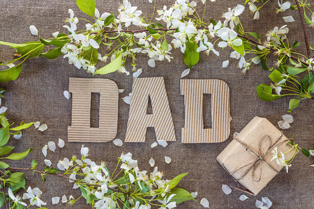 Fathers Day message from cardboard letters and a gift box with apple blossoms. Happy fathers day concept.の写真素材