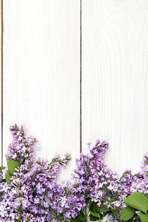 Lilac flowers on white wooden background. Top view, flat lay, copy space. Spring flowers.の写真素材