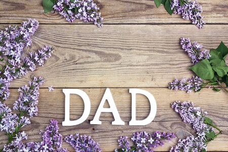 Fathers day background with letters and lilac flowers on old wooden table. Copy space. Happy fathers day concept.の写真素材