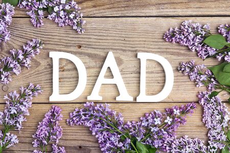 Fathers day background with letters and lilac flowers on old wooden table. Happy fathers day concept.の写真素材