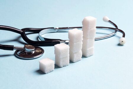 Sugar chart with stethoscope on blue background. World diabetes day, 14 november.の写真素材
