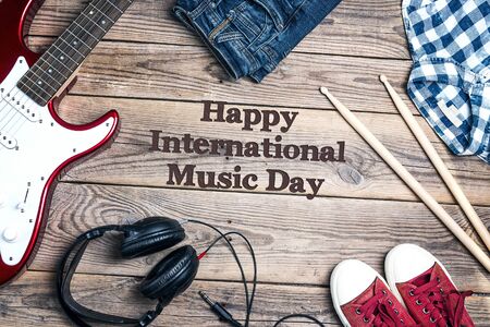 International Music Day background with music equipment, clothes and footwear on wooden background.の写真素材
