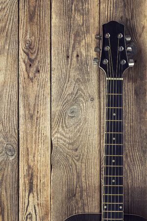 Grif guitar on the background of old grunge boards. Place for text. Vertical.の写真素材