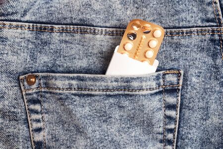 Female oral contraceptive pills blister in jeans pocket. Women contraceptive hormonal birth control...