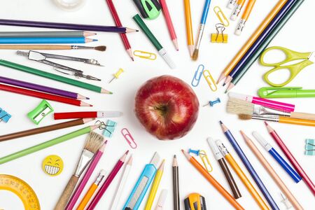 Back to school concept with school supplies and red apple on white background. Top view.の写真素材