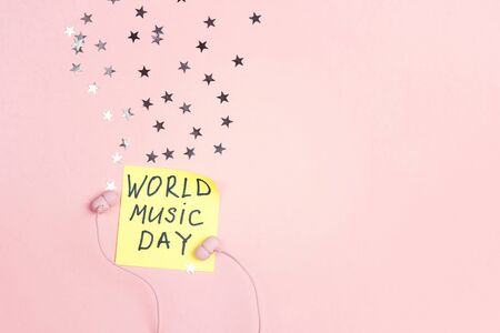 International Music Day background with earphones and stars on pink background. Top view, flat lay.の写真素材