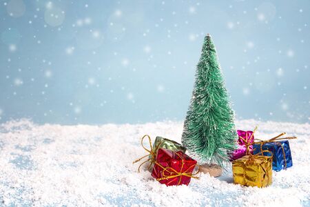 Miniature Christmas Tree with gift boxes. Copy space for text. Winter card. Holiday and celebration concept.の写真素材