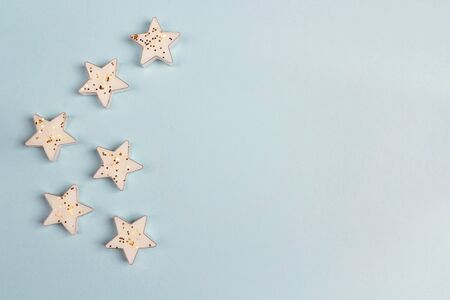 Border of star candles on blue background with copy space. Top view, flat lay.
