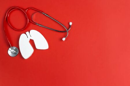 Prevention of pulmonary disease. Lung symbol and stethoscope on a red background. Healthcare and medicine concept.の写真素材