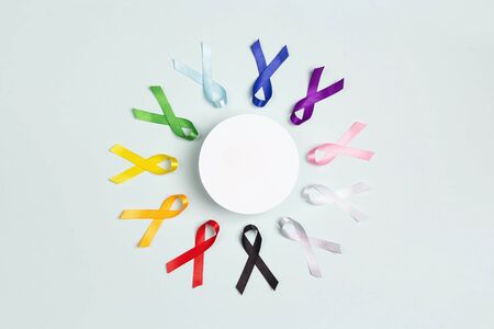 Circle of  colorful awareness ribbons with place for text on blue background. World cancer day concept, February 4. Healthcare and medicine concept. の写真素材