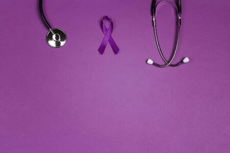 Purple epilepsy awareness ribbon with stethoscope and copy space on a purple background. World epilepsy day. Purple Day. の写真素材