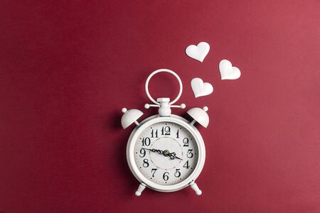 Alarm clock in love on red background. Place for text, top view, flat lay. の写真素材