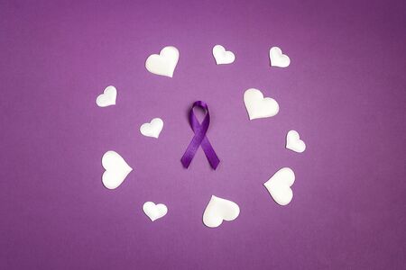 Purple epilepsy awareness ribbon wit white heats on a purple background. World epilepsy day. Purple Day. の写真素材