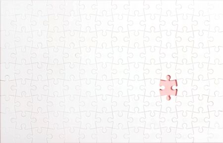 White puzzle pieces with one lost piece. Copy space, top view.の写真素材