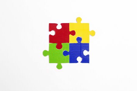 Four colored puzzle pieces on a white background. Autism Awareness Day. Autism Spectrum Disorder (ASD) concept.の写真素材