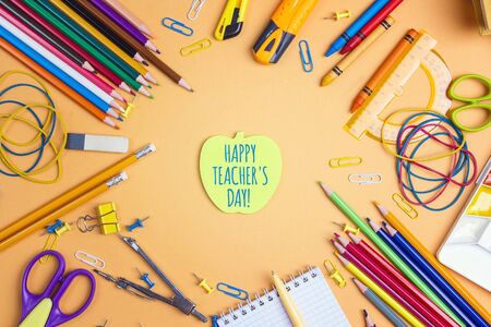 Teacher's day concept with apple note and school supplies on yellow background. Card, invitation or greeting template.の写真素材