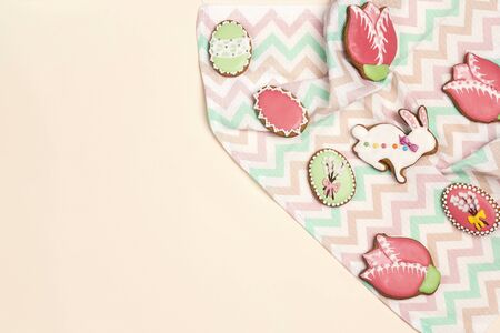 Easter homemade gingerbread cookies on the napkin on a light background with copy space. Gingerbread...