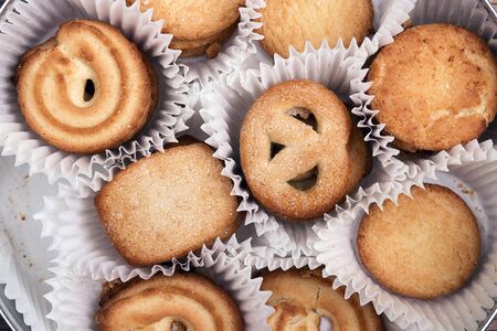 Set of traditional Danish butter cookies from Denmark in paper cases. Closeup, top view.