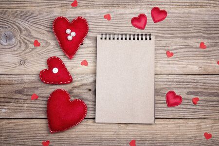 Open blank notebook  with Valentine hearts on old wooden background. Copy space. Valentines day background. Top view.の写真素材
