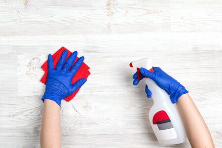 Hands in a rubber gloves disinfects the surface with a antibacterial sanitizer. Coronavirus prevention.の写真素材