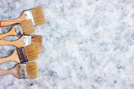 Brush border on gray canvas background. Copy space for text. View from above.の写真素材