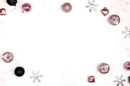 Christmas frame made of decorations on a white background. Copy space, top view, flat layer.