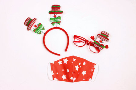 Set of party horns, funny glasses and medical mask on a white background. Safe Christmas celebration during the coronavirus. Flat lay design.の写真素材