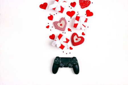Joystick with romantic decorations on white background. Holidays gaming concept. St. Valentines Day...
