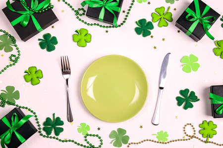Festive table setting for St. Patrick's day with cutlery and lucky symbols on white table. Copy spase, top view.の写真素材