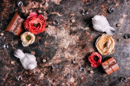 Festive frame with peony flowers, gifts and birds on brown marble. Top down composition with copy space. Valentine's Day, Mother's Day or 8 March greeting card.の写真素材