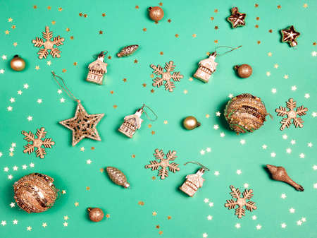 Golden decorations on a green background. Top view Christmas composition.の写真素材
