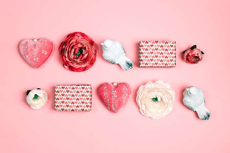 Romantic top down composition of the gifts, birds, flower and hearts on pink background. St....