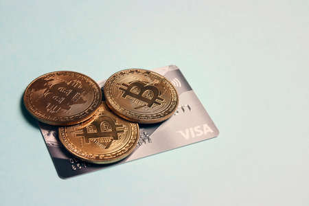 Bitcoin and Visa credit card. Visa card and bitcoin cryptocurrency payment concept. Ufa, Russia -...