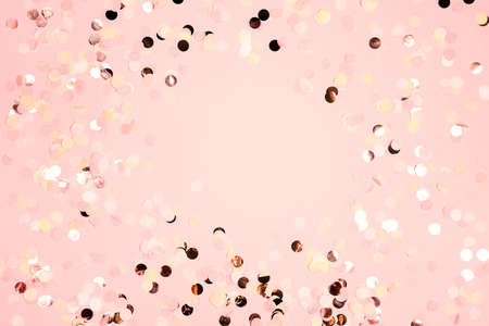 Colorful round festive confetti dots on pink background. Holiday greeting card for Christmas, New year, mother's day, wedding, birthday. Flat lay, top view, copy space.の写真素材