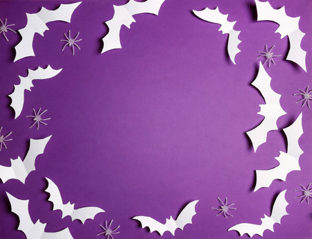 Halloween flat lay composition with white bats and spiders on purple background. Happy halloween banner mockup. Flat lay, top view, copy space.の写真素材