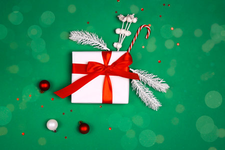 Green Christmas background with gifts and decorations. top down composition.の写真素材
