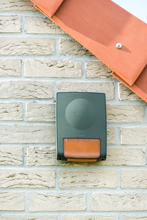 Alarm in a wall of house